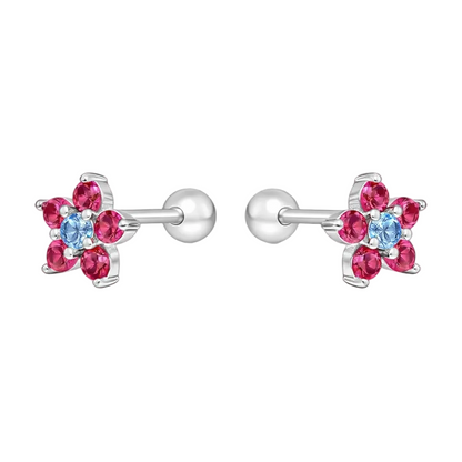 "Aros de plata ley 925 con forma de flor, pétalos de circones fucsias y centro celeste, con tornillo de seguridad de pelotita."